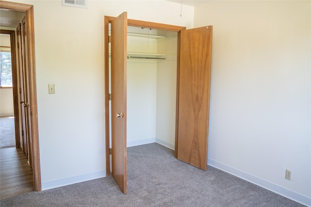 180 1st St, Gilbert, IA 50105 - unfurnished bedroom with baseboards, visible vents, a closet, and carpet
