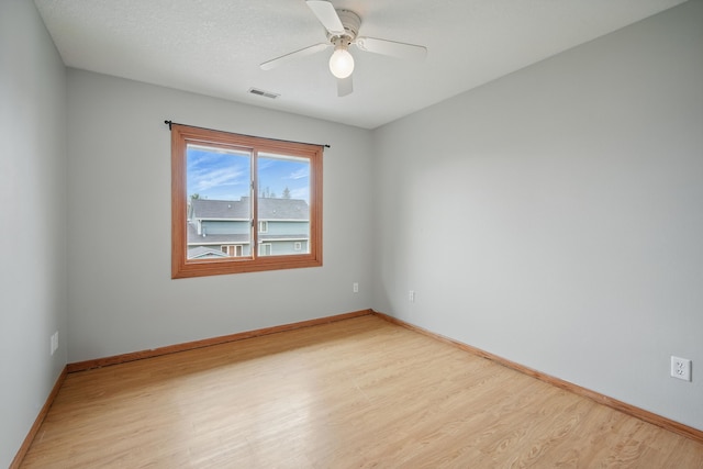 1410 Alderwood Dr, Altoona, IA 50009 - spare room with light wood finished floors, visible vents, ceiling fan, and baseboards