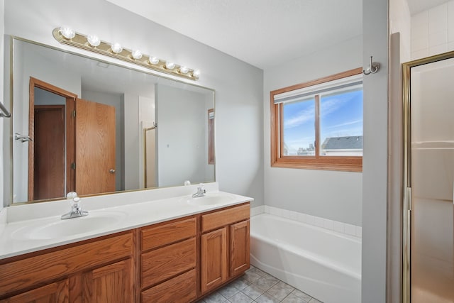 1410 Alderwood Dr, Altoona, IA 50009 - bathroom featuring double vanity, tile patterned floors, a bath, and a sink