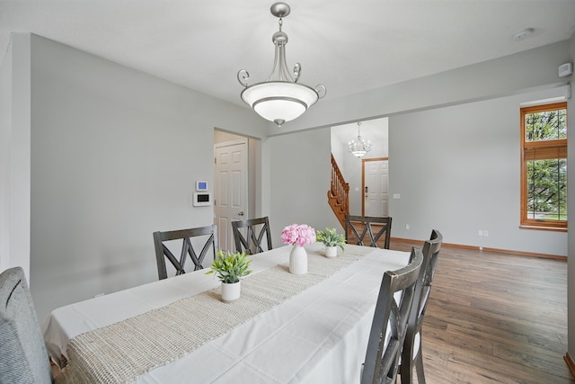 1410 Alderwood Dr, Altoona, IA 50009 - dining room with a chandelier, baseboards, wood finished floors, and stairs