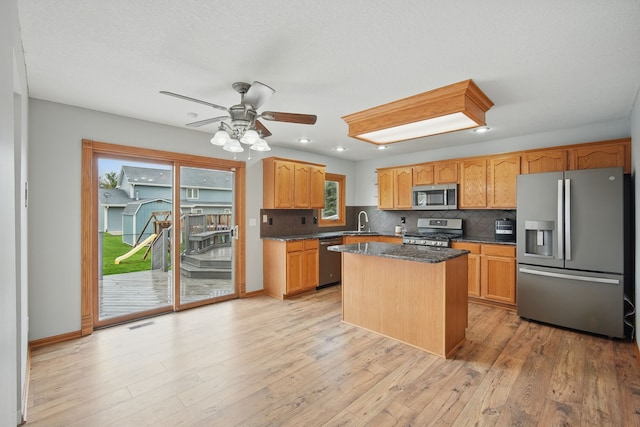 1410 Alderwood Dr, Altoona, IA 50009 - kitchen with a sink, stainless steel appliances, light wood-style floors, ceiling fan, and backsplash