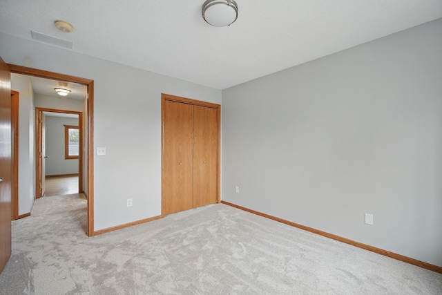 1410 Alderwood Dr, Altoona, IA 50009 - unfurnished bedroom featuring visible vents, a closet, baseboards, and light carpet