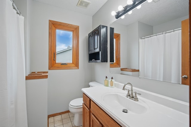 1410 Alderwood Dr, Altoona, IA 50009 - bathroom featuring tile patterned flooring, toilet, vanity, baseboards, and visible vents