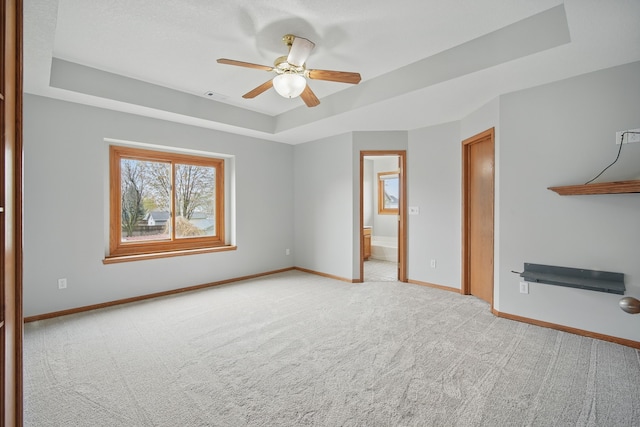 1410 Alderwood Dr, Altoona, IA 50009 - spare room featuring a ceiling fan, baseboards, light colored carpet, and a tray ceiling