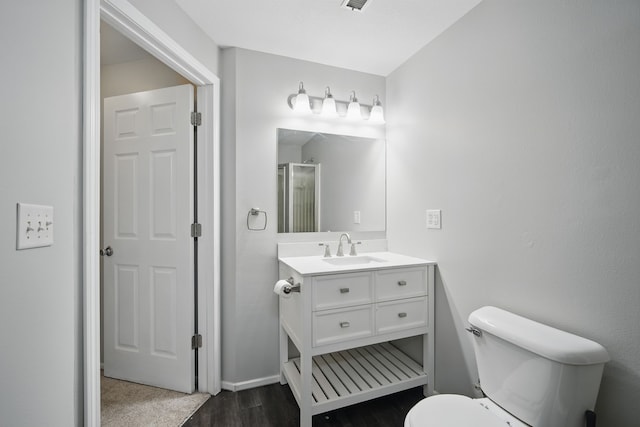 1410 Alderwood Dr, Altoona, IA 50009 - bathroom with wood finished floors, toilet, vanity, baseboards, and visible vents