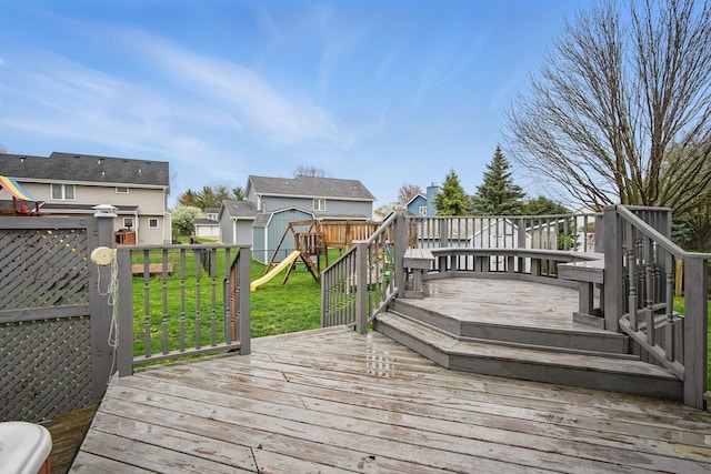 1410 Alderwood Dr, Altoona, IA 50009 - deck with a lawn, a storage shed, a fenced backyard, and a playground