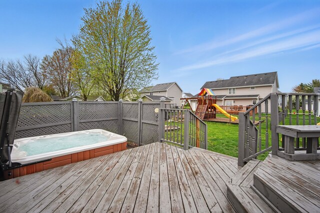 1410 Alderwood Dr, Altoona, IA 50009 - wooden terrace featuring a fenced backyard, a yard, an outdoor hot tub, a residential view, and a playground