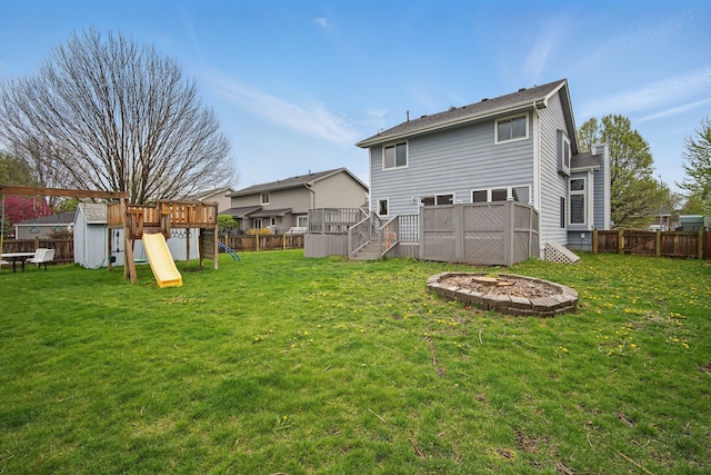 1410 Alderwood Dr, Altoona, IA 50009 - back of property featuring a lawn, a playground, and a fenced backyard