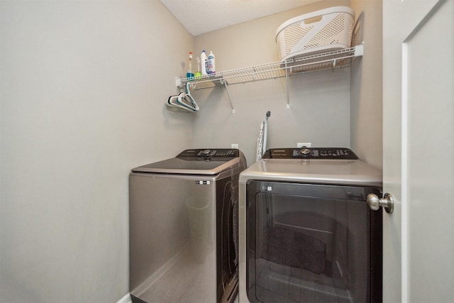 washroom featuring laundry area and washing machine and dryer