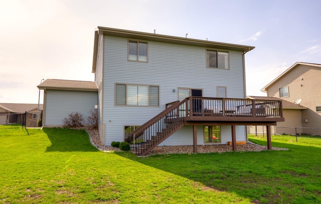 rear view of property with a deck, a yard, stairway, and fence