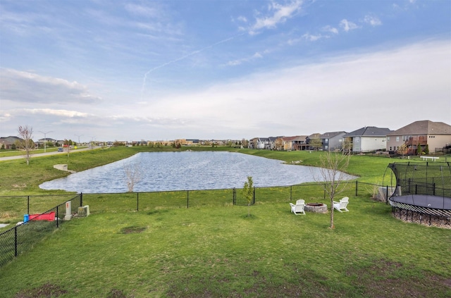 property view of water with a residential view, an outdoor fire pit, and fence