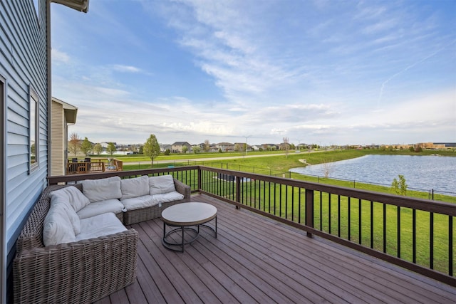 wooden deck featuring a yard, an outdoor hangout area, and a water view