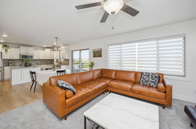living room with recessed lighting, a ceiling fan, and light colored carpet