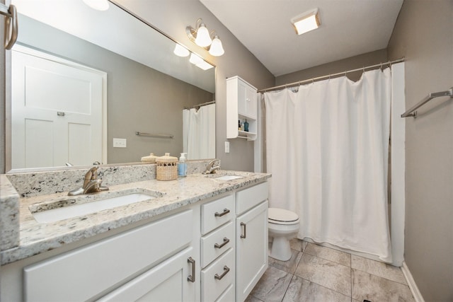 full bathroom with baseboards, toilet, double vanity, and a sink