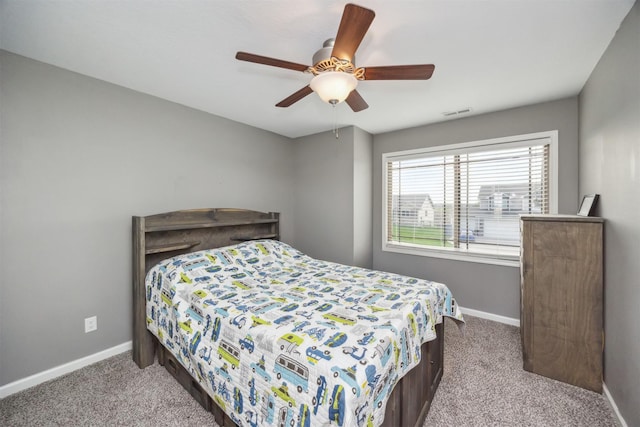 bedroom with baseboards, visible vents, ceiling fan, and carpet flooring