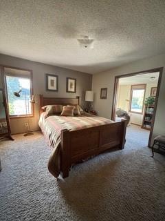 1301 Florida Ave, Ames, IA 50014 - carpeted bedroom featuring a textured ceiling