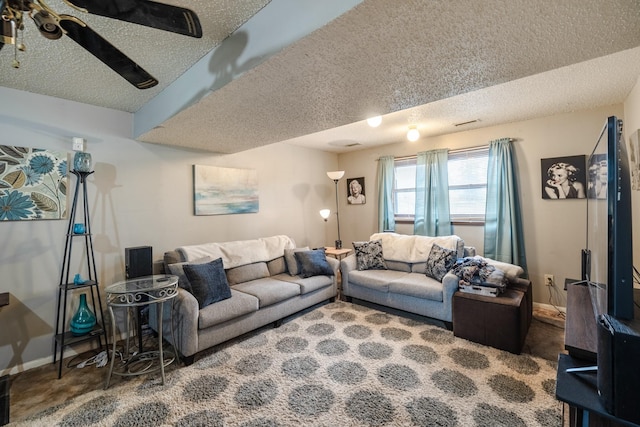 carpeted living room with a textured ceiling and baseboards
