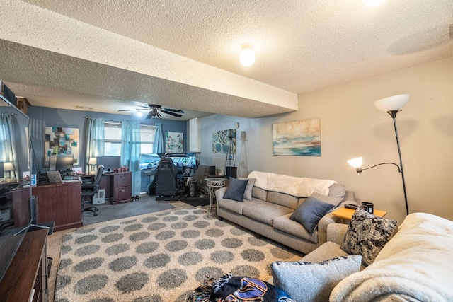 carpeted living area with a textured ceiling and ceiling fan