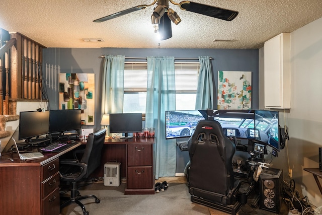 home office featuring a textured ceiling, visible vents, a ceiling fan, and carpet floors