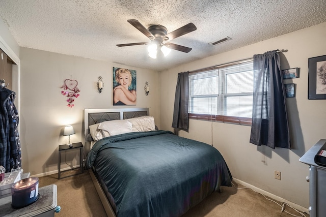 bedroom with a textured ceiling, visible vents, carpet flooring, and baseboards