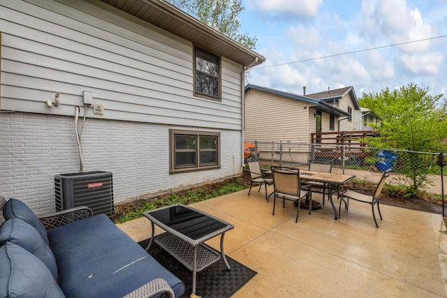 view of patio / terrace featuring cooling unit, outdoor dining space, and fence