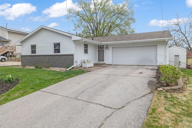 ranch-style house with brick siding, a shingled roof, a garage, driveway, and a front lawn