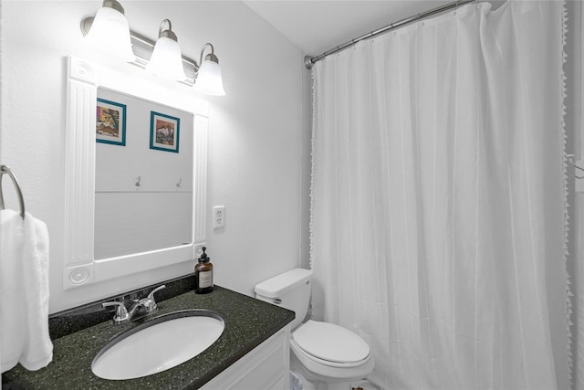 bathroom with toilet, vanity, and a shower with shower curtain