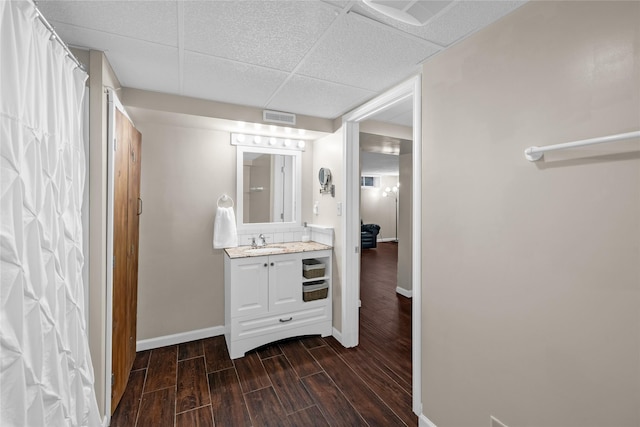 full bath with vanity, visible vents, wood finished floors, and baseboards
