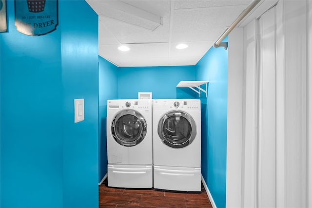 laundry area with recessed lighting, laundry area, dark wood-style flooring, washing machine and dryer, and baseboards