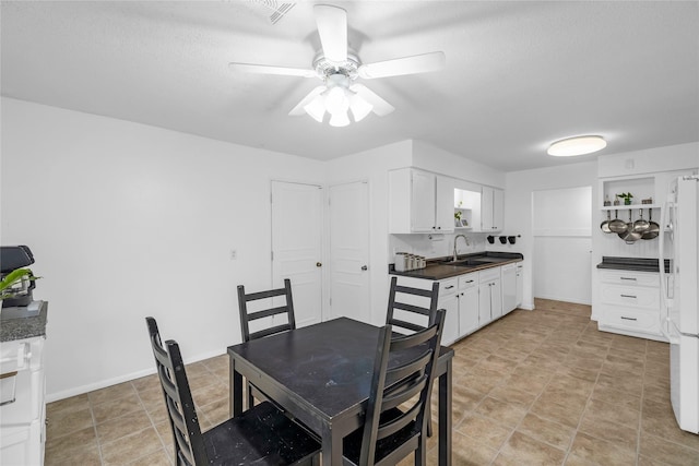 dining space featuring light tile patterned flooring, ceiling fan, and visible vents