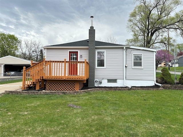 rear view of property featuring a chimney, a deck, a yard, and roof with shingles