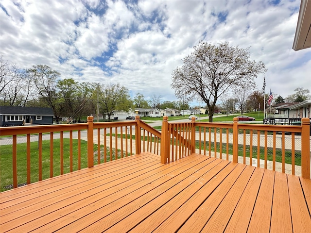 wooden deck with a yard and a residential view