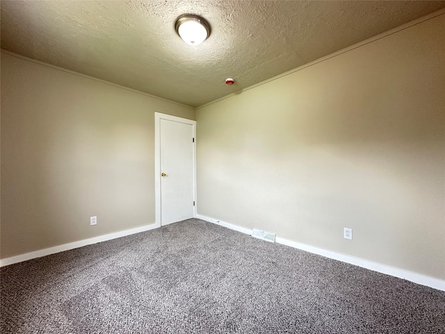 unfurnished room featuring a textured ceiling, visible vents, dark carpet, and baseboards