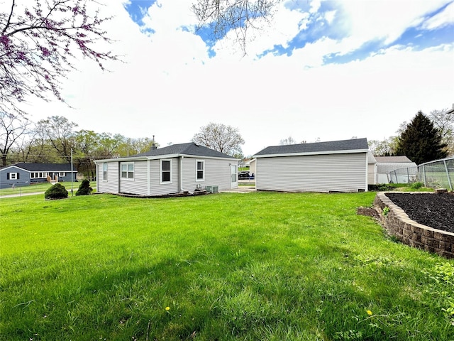 exterior space featuring a lawn and fence