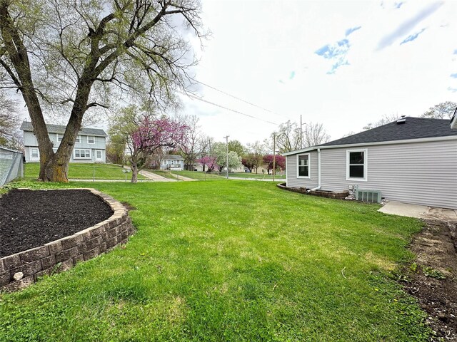 view of yard featuring central air condition unit