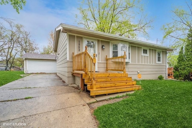 view of front of property with a front yard and a garage