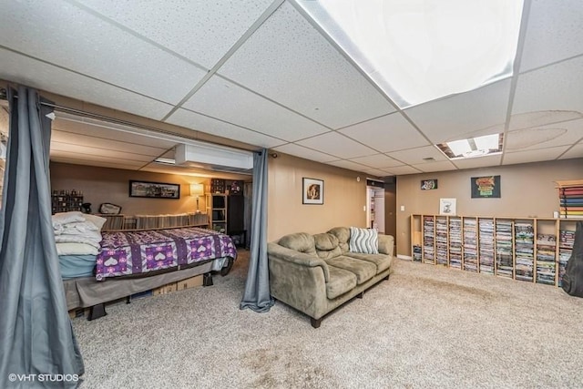 bedroom with a paneled ceiling and carpet flooring