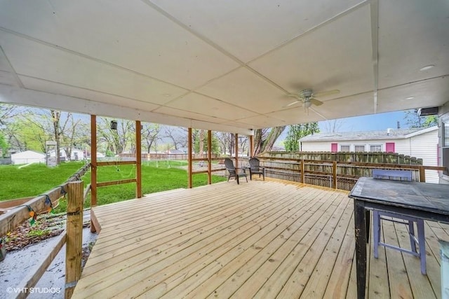 deck featuring fence, a ceiling fan, and a yard