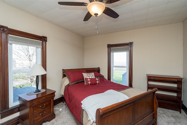 bedroom featuring ceiling fan and light carpet