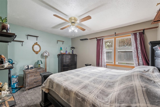 carpeted bedroom with ceiling fan and a textured ceiling