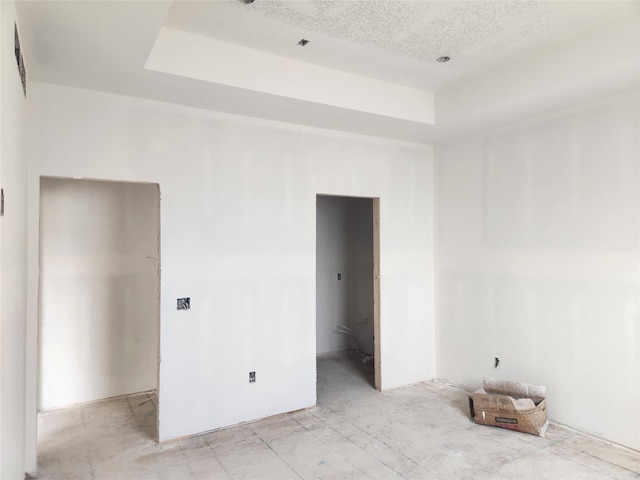 unfurnished bedroom featuring a raised ceiling