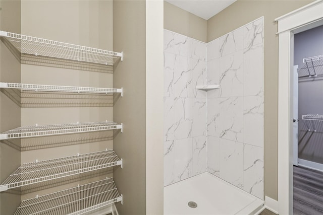 2323 N 8th Ave E, Newton, IA 50208 - bathroom featuring a shower and wood finished floors