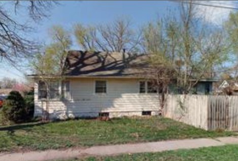 view of home's exterior featuring fence and a yard