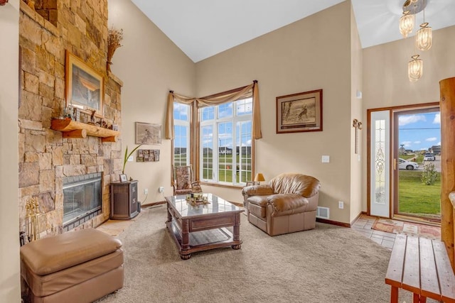 6991 NE 27th Ave, Altoona, IA 50009 - carpeted living area featuring high vaulted ceiling and a stone fireplace