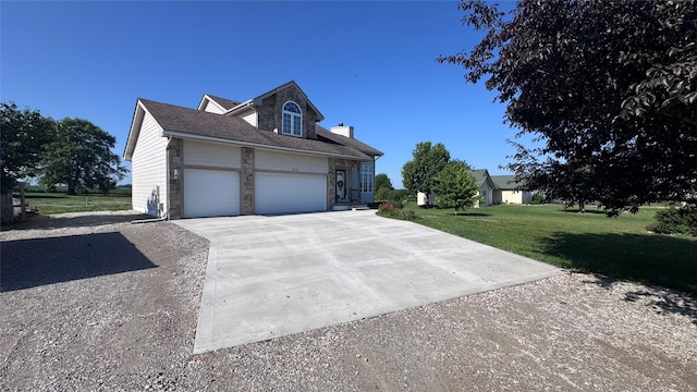 6991 NE 27th Ave, Altoona, IA 50009 - view of front facade with concrete driveway, stone siding, a garage, and a front yard