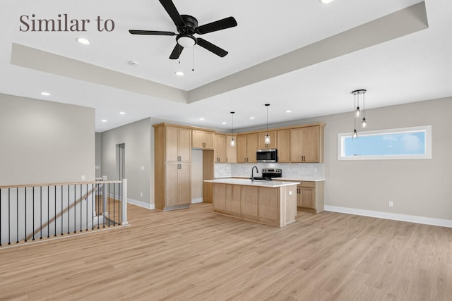 2931 Lake Hill Dr, Des Moines, IA 50320 - kitchen with stainless steel appliances, light countertops, recessed lighting, light wood-style flooring, and decorative backsplash