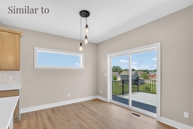 2931 Lake Hill Dr, Des Moines, IA 50320 - unfurnished dining area with light wood-style floors and plenty of natural light