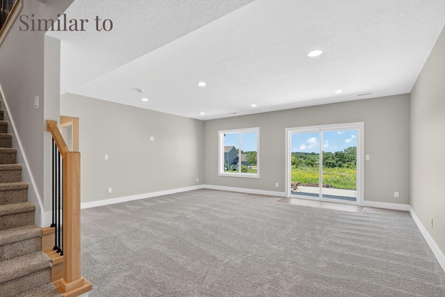2931 Lake Hill Dr, Des Moines, IA 50320 - unfurnished living room with carpet flooring, stairs, recessed lighting, and a textured ceiling