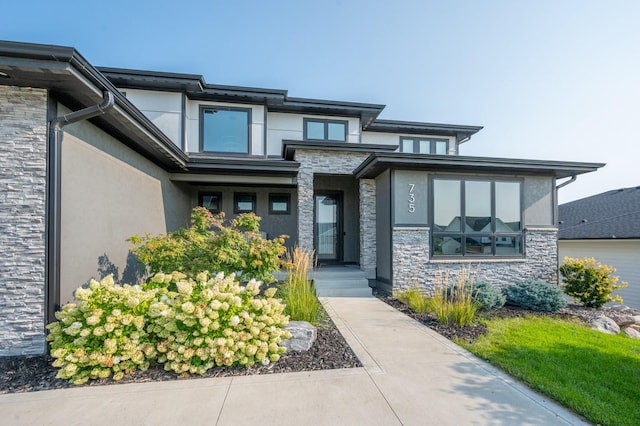 property entrance featuring stone siding and stucco siding