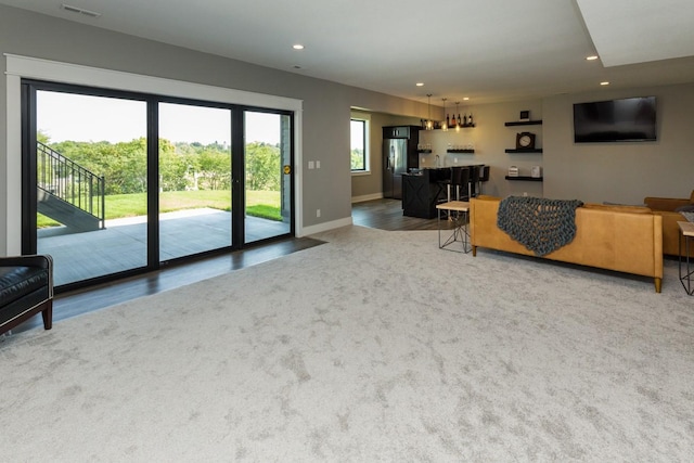living area featuring bar area, recessed lighting, carpet, baseboards, and visible vents